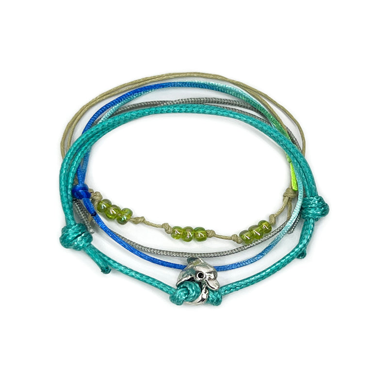 Green dolphin charm bracelet with nature-inspired bead design and adjustable cord from O Yeah Gifts.