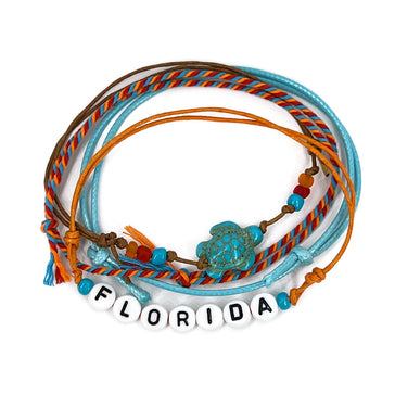 Blue Florida Letter Bead Bracelet with ocean-blue beads and a playful sea turtle charm, part of the O Yeah Gifts style pack. Perfect for stacking, sharing, and showing off tropical Florida vibes.