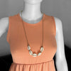 Linn the mannequin wearing an adjustable Beige Cowrie Shell Necklace long by O Yeah Gifts!