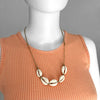 Linn the mannequin wearing an adjustable Beige Cowrie Shell Necklace medium by O Yeah Gifts!
