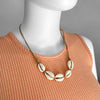 Linn the mannequin wearing an adjustable Beige Cowrie Shell Necklace short by O Yeah Gifts!