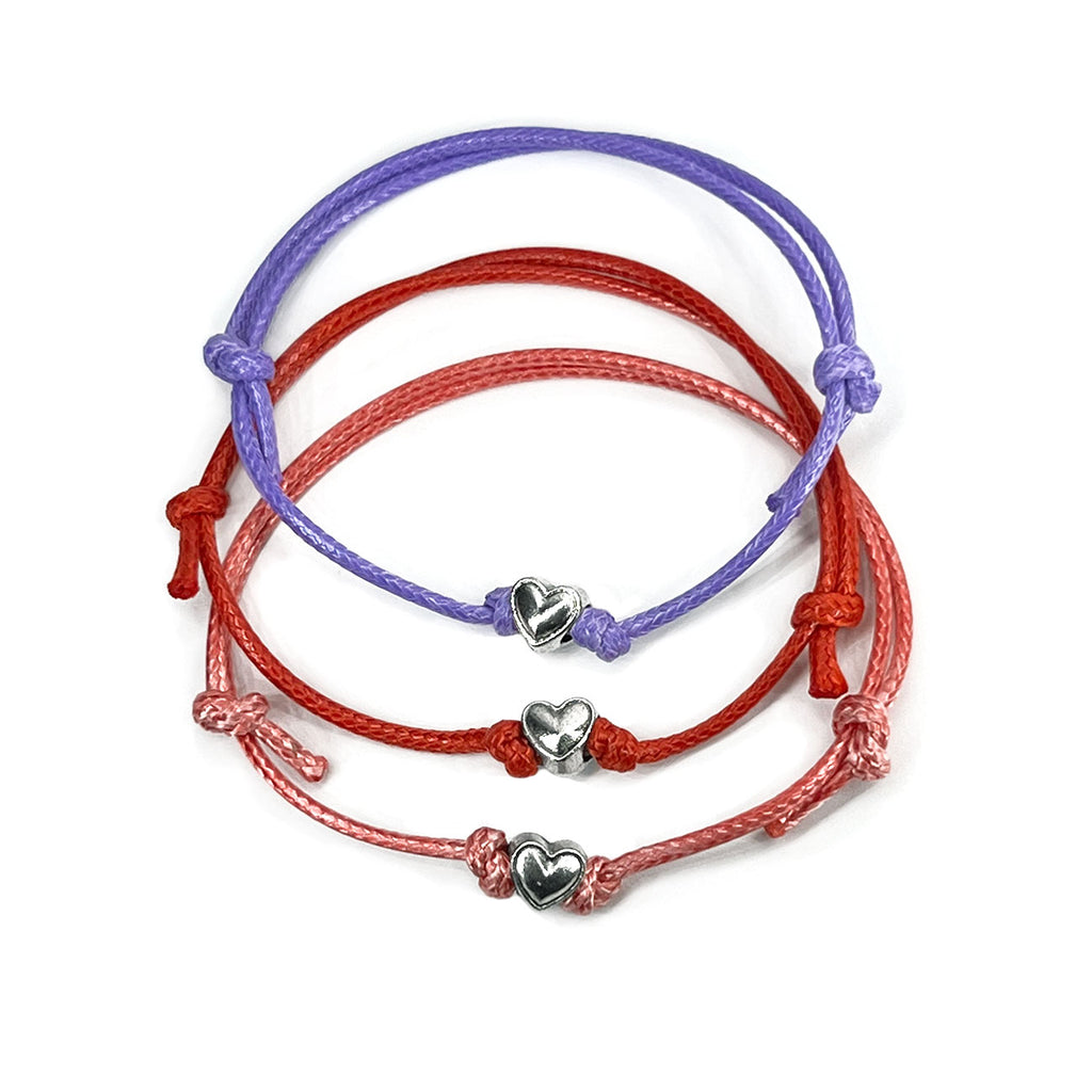 O Yeah Gifts Heart Charm Bracelets – Set of three adjustable bracelets in purple, red, and pink cords with silver heart charms, perfect for besties and BFFs to share.