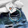 O Yeah Gifts 4-piece Wave Charm Bracelet Pack with adjustable string cords, beaded bracelets and silver wave charm styled on denim and white knitwear made by O Yeah Gifts