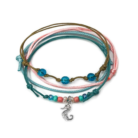 Seahorse Bracelet Style Pack: 4 blue, pink, turquoise and beige bracelets with a silver-tone seahorse charm, on white