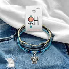 Black Sea Turtle Bracelet Style Pack on its O Yeah 4-piece adjustable bracelet card, laid on denim and a white tee