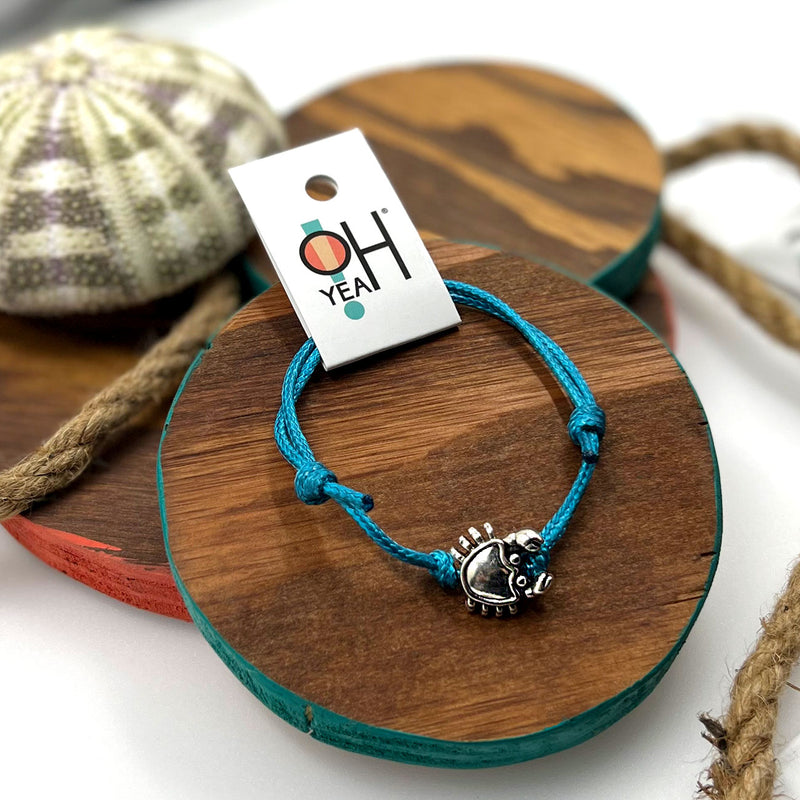 O Yeah Gifts Crab Bracelet – Summer beach jewelry featuring a silver crab charm and vibrant blue cord, ideal for ocean lovers and seaside adventures.