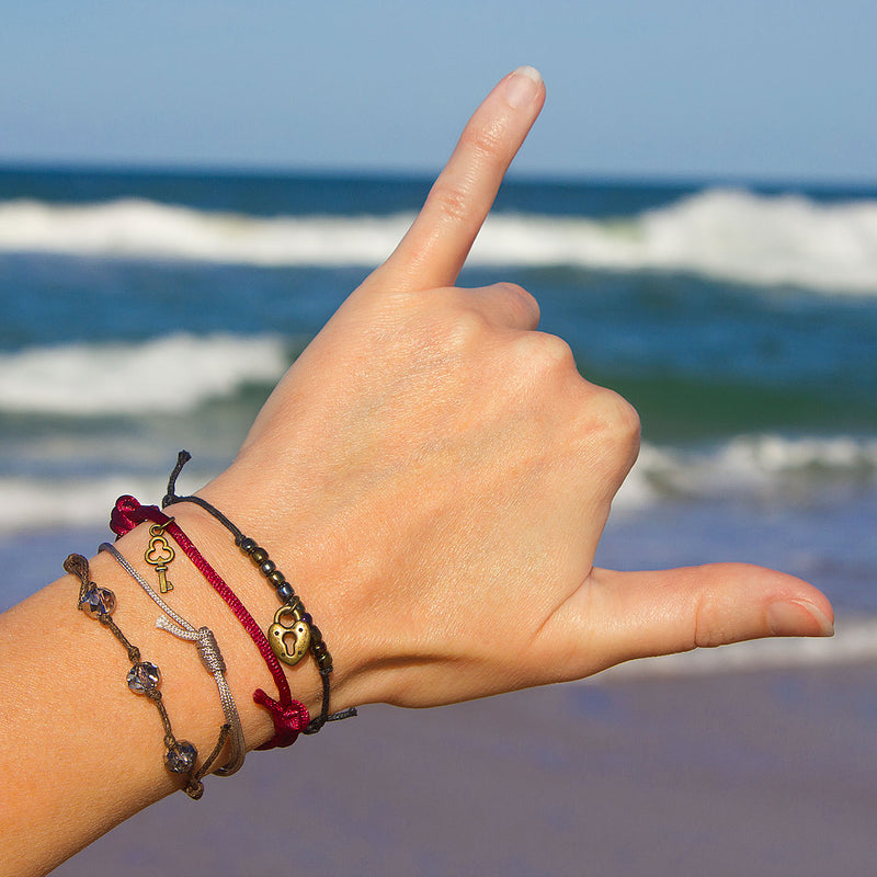 Close-up of Lock and Key Bracelet – detailed charm design with adjustable cord for beachy, symbolic jewelry.