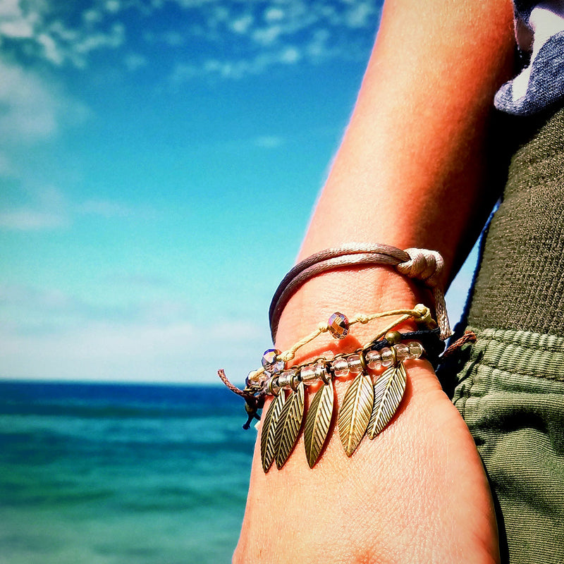 New Year's bracelet with leaf charm and beaded accents for a chic look at the beach.