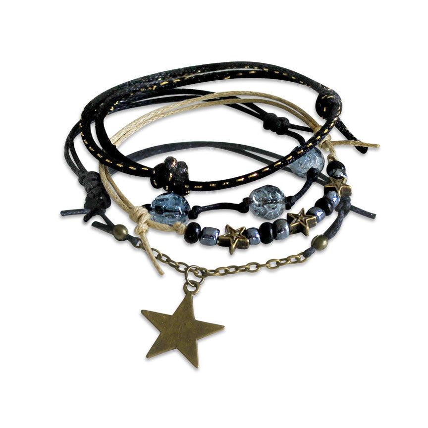 Star Gaze Bracelet with beaded design stacked with charm bracelets.