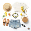 Flat lay of a sunny summer outfit with straw hat, honey jar and dipper, yellow daisies, cream crochet crop top, ripped denim shorts, tan slides, round straw bag, black sunglasses and yellow bee charm bracelet stack from O Yeah Gifts; lifestyle jewelry image, ai jewelry image, ai bracelet photo, product photography jewelry, trend jewelry photography.