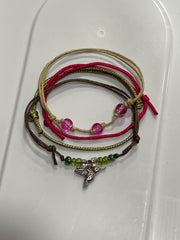 Green hummingbird bracelet stack on white: 4 adjustable string bracelets in green, pink, beige with a silver-tone hummingbird