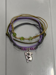 Gray koala bracelet stack on white: 4 adjustable string bracelets in gray, purple, beige with a silver-tone koala charm.