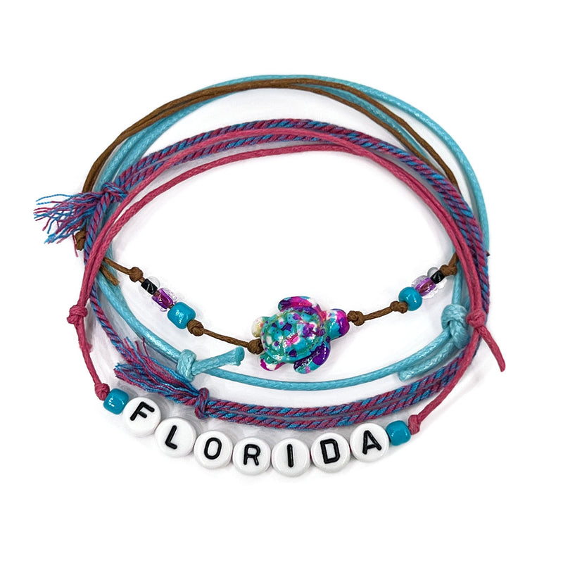 Florida Letter Bead Bracelet with pink and ocean-colored beads featuring a sea turtle charm, part of the O Yeah Gifts style pack. Perfect for beach lovers and fans of Taylor Swift's tropical playful vibes.