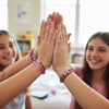 Girly crew of teens wearing O Yeah Gifts Pink 67 Bracelets high-fiving, showing pink, white and brown string cords with 67 beads, a fun six seven meme bracelet used in the 6-7 hand gesture trend and viral meme friendship jewelry. What does 6-7 mean bracelet.