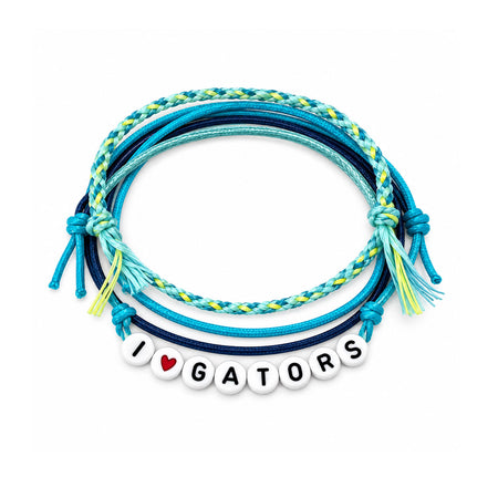 A stack of braided and knotted cord bracelets in shades of blue, teal, and yellow, with a white beaded charm spelling 'I' followed by a red heart and 'GATORS'.