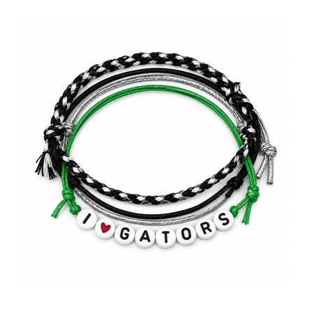A set of five coiled bracelets on a white background, featuring black and white braided cords, a bright green cord, a silver cord, and white letter beads spelling 'I [red heart] GATORS'.