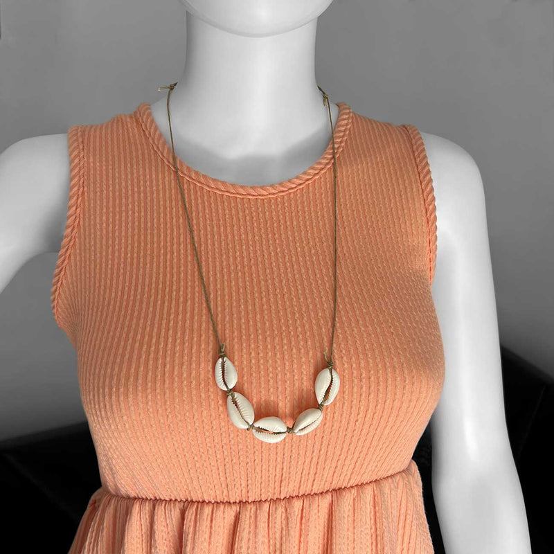 Linn the mannequin wearing an adjustable Beige Cowrie Shell Necklace long by O Yeah Gifts!