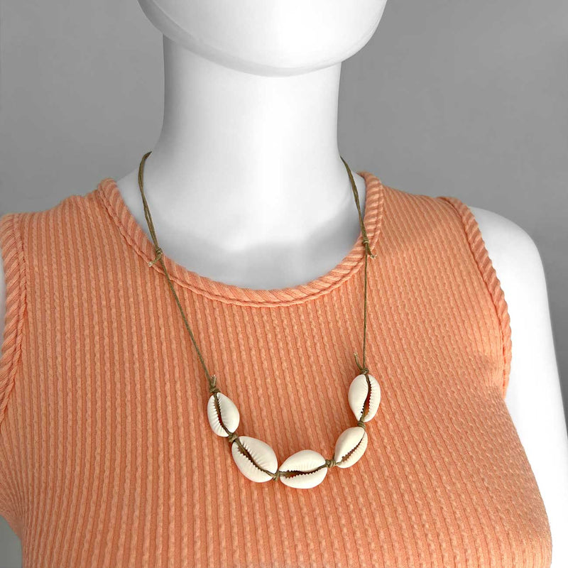 Linn the mannequin wearing an adjustable Beige Cowrie Shell Necklace medium by O Yeah Gifts!