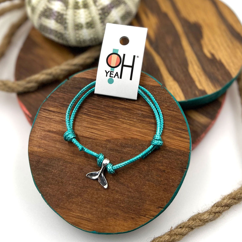 Whale Tail Charm Bracelet by O Yeah Gifts – Featuring a silver whale tail on a turquoise cord, bringing sea-inspired style and a touch of the ocean to any outfit.