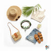Flat lay of a tropical summer outfit with straw hat, palm leaf, cream crop top, ripped denim shorts, tan sandals, woven crossbody bag and green palm tree charm bracelet stack from O Yeah Gifts; lifestyle beach jewelry, ai jewelry image, ai bracelet photo.