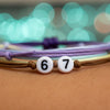 Macro close-up of a purple and blue string 67 bracelet with white beads reading 6 and 7, minimalist 6-7 meme bracelet and pixel vibe bracelet aesthetic from O Yeah Gifts, neon vibe bracelet look that taps into six seven meme culture, what does 6-7 mean answered as IYKYK accessory, gen alpha 6-7 and new gen z slang jewelry, 67 trend bracelet and 6-7 jewelry for fans of the 6-7 TikTok trend, six seven funny gift, 6-7 meme merchandise and 67 TikTok jewelry, 67 vibe trending for gen alpha meme jewelry.