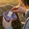 67 crew student sliding a purple 67 bracelet gift box into a backpack pocket, purple 6-7 meme bracelet from O Yeah Gifts as a surprise six seven funny gift, viral 6-7 trend accessory and school safe bracelet for the first day of school, 6-7 friendship bracelet gift and matching bracelets teens can trade, 6-7 meme accessory for teens who follow the 6-7 kid TikTok and Mr 6-7 Taylen Kinney, six seven meme drip with gen alpha brain rot aesthetic buy 6-7 bracelet online as 6-7 meme merchandise 67 trend bracelet.