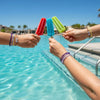 67 friends clinking colorful popsicles over a pool, both wrists stacked with purple 67 bracelets from O Yeah Gifts, summer party scene with 6-7 meme bracelet and six seven meme accessory, viral 6-7 trend accessory and gen alpha meme jewelry, IYKYK 6-7 jewelry that works as matching bracelets teens and bestie bracelets, six seven funny gift and 6-7 meme merchandise you can buy 6-7 bracelet online, 67 trend bracelet for pool days, friendship bracelet trend and tradeable bracelets.