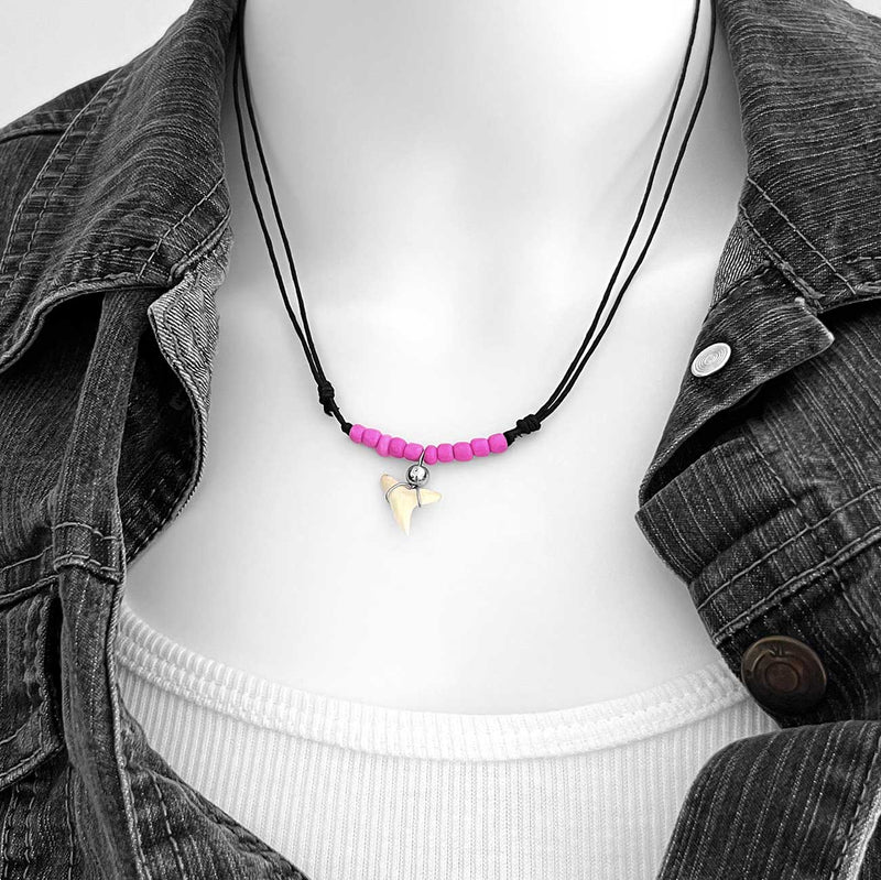 Shark tooth necklace with pink beads and adjustable black cord, beach surfer necklace with wrapped tooth pendant on Linn the mannequin