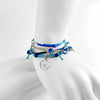 Stacked Wave Bracelets worn on wrist, featuring adjustable beaded bracelet cords in ocean blues with silver wave charm and sea glass accents from O Yeah Gifts