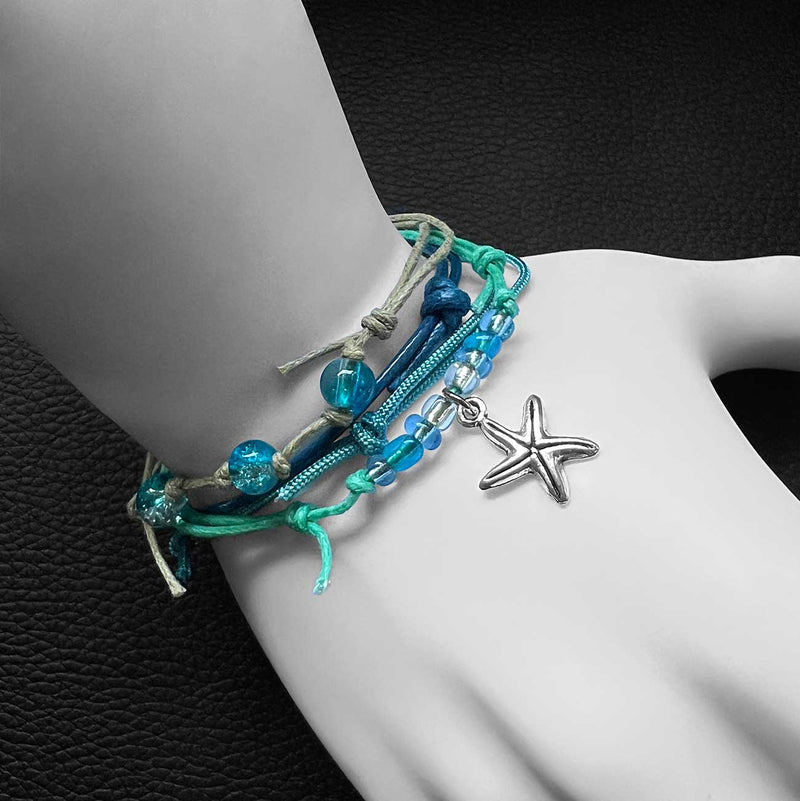 Starfish Charm Bracelet Pack with multistrands stackable beach bracelets with blue beads and starfish charm on a wrist against a dark background