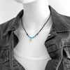 Shark tooth necklace with blue beads and black cord, unisex adjustable surfer jewelry, wire-wrapped tooth pendant on model in denim jacket
