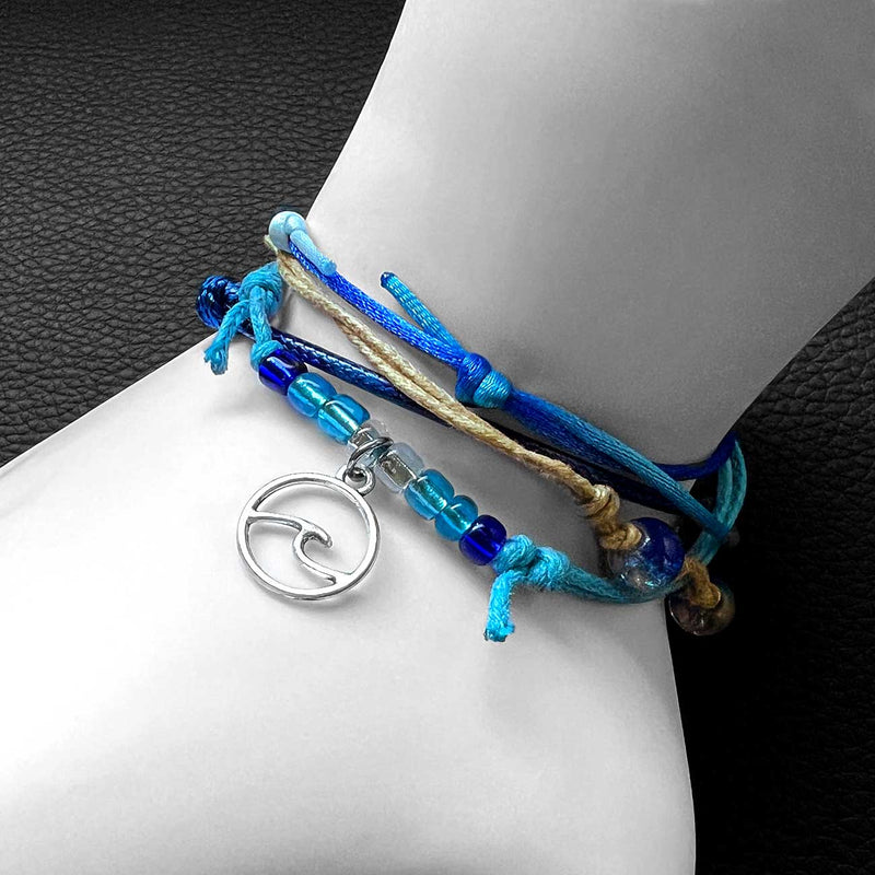 Stackable adjustable wave bracelet with silver wave charm, beaded sea glass accents, and waterproof string cord bracelets in ocean blues from O Yeah Gifts sold wholesale. 
