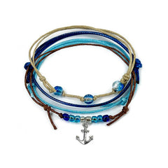 Blue anchor bracelet stack on white: 4 adjustable string bracelets in blue, beige, brown with a silver-tone anchor charm.