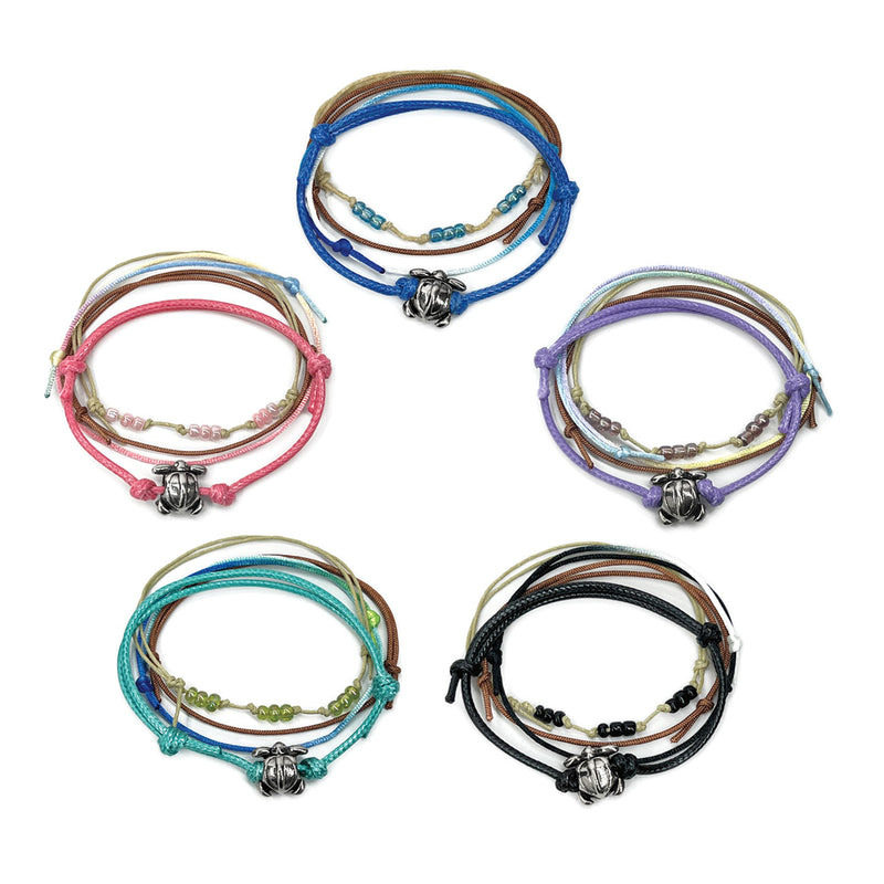 Beaded silver sea turtle bracelets with colorful string and bead designs, featuring an adjustable fit and silver sea turtle charm, available in multiple colors for ocean lovers and beach enthusiasts.