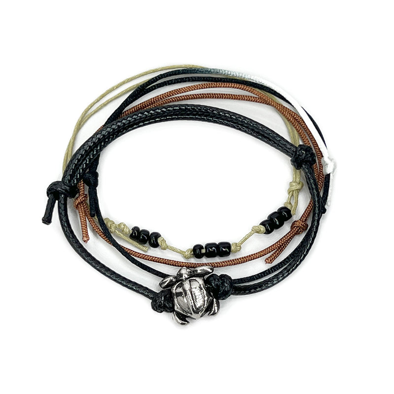 Black sea turtle bead bracelet with an adjustable string design, featuring a silver sea turtle charm and black bead accents, perfect for ocean lovers and beach enthusiasts.