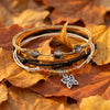 Orange Butterfly Bracelet Style Pack resting on orange autumn leaves
