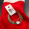 Christmas Shell Bracelet Pack – 4-piece set with red, green, and tan cords featuring a white shell charm, perfect for holiday beach vibes and gifting.