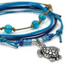 Close-up of the silver-tone sea turtle charm with blue, purple and clear beads on the Blue Sea Turtle Bracelet Style Pack