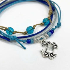 Close-up of the silver-tone crab charm and the glass beads on the Crab Bracelet Style Pack.