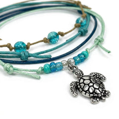 Close-up of the silver-tone sea turtle charm with seafoam, aqua and clear beads on the Green Sea Turtle Bracelet Style Pack