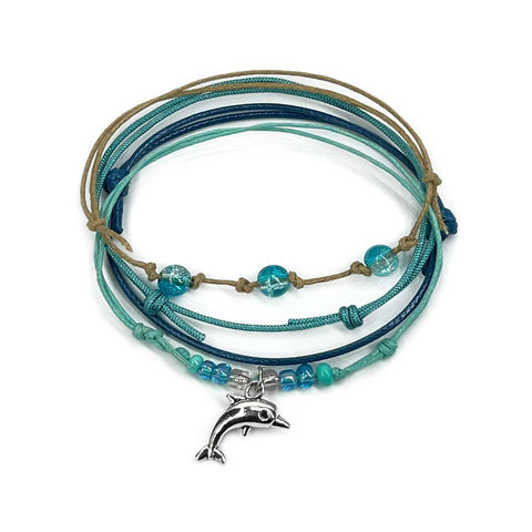 Dolphin Bracelet Style Pack in Green: 4 seafoam, teal, navy and tan bracelets with a silver-tone dolphin charm, on white