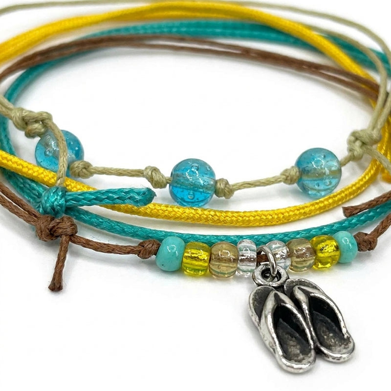 Close-up of the silver-tone flip flop charm and the glass beads on the Flip Flop Bracelet Style Pack.