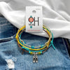 Flip Flop Bracelet Style Pack on its O Yeah four-piece hang tag, laid on denim and a white tee.