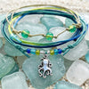 Octopus charm bracelets styled on sea glass and sand