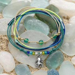 Octopus Bracelet Style Pack hero - four stackable waterproof beach bracelets with a silver octopus charm