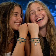 Friends wearing matching octopus charm bracelets at the aquarium
