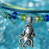 Silver octopus charm detail on an adjustable waterproof cord bracelet
