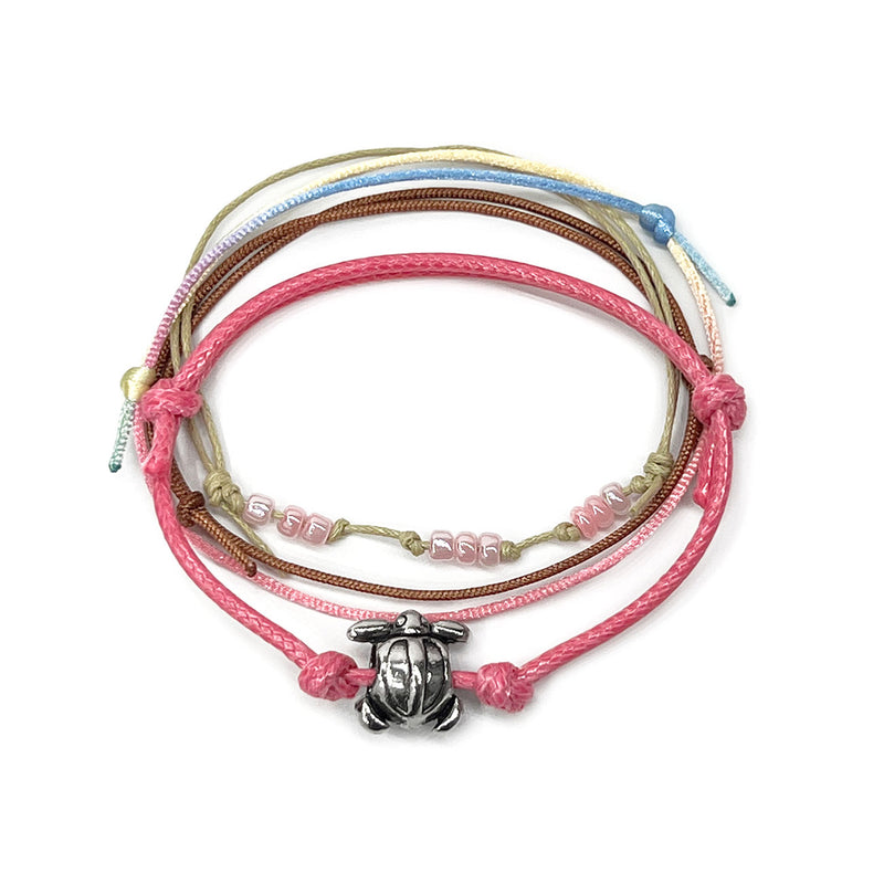 Pink sea turtle bead bracelet with an adjustable string design, featuring a silver sea turtle charm and pink bead accents, perfect for ocean lovers and beach enthusiasts.