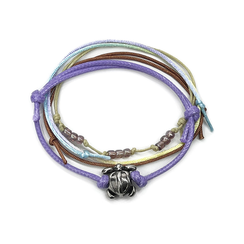 Purple sea turtle bead bracelet with an adjustable string design, featuring a silver sea turtle charm and pink bead accents, perfect for ocean lovers and beach enthusiasts.