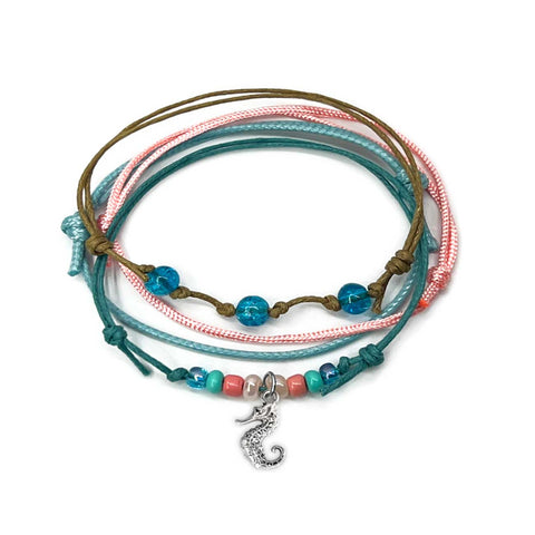 Seahorse Bracelet Style Pack: 4 blue, pink, turquoise and beige bracelets with a silver-tone seahorse charm, on white